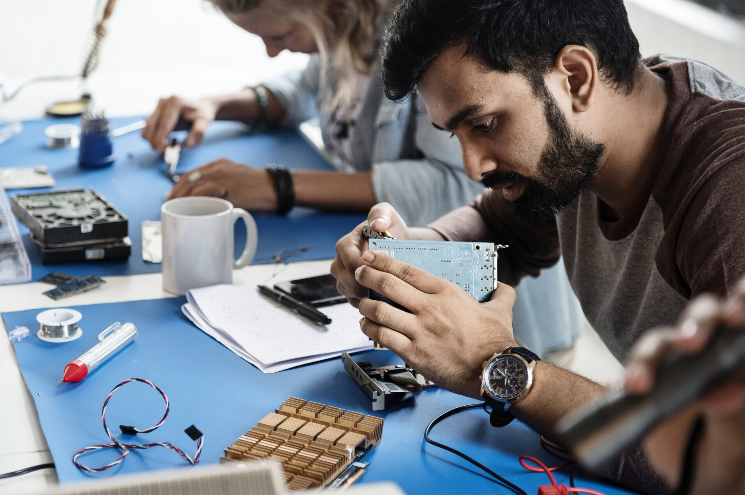 Electrical technicians working on electronics parts Employee traing to repair electronics